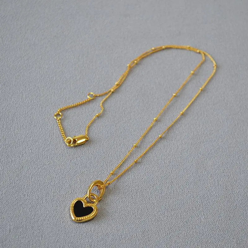 Black and white necklace with gold heart
