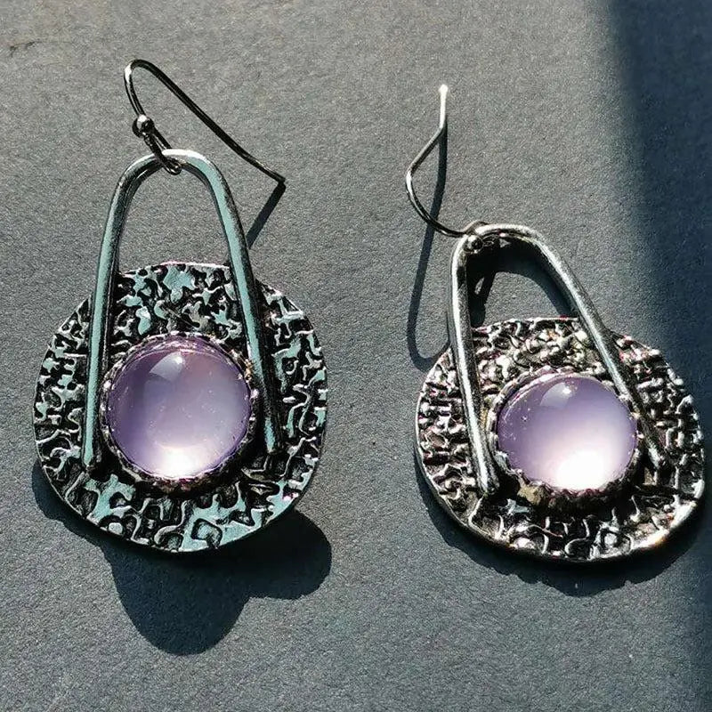 Boho earrings with purple stones in silver setting