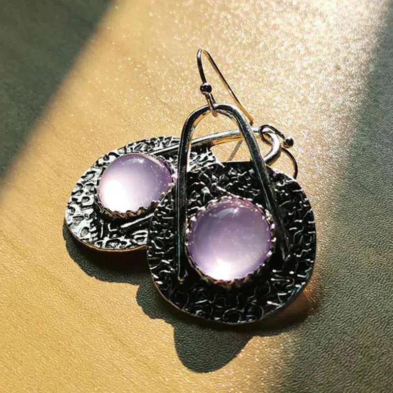 Boho earrings with purple stones in silver setting