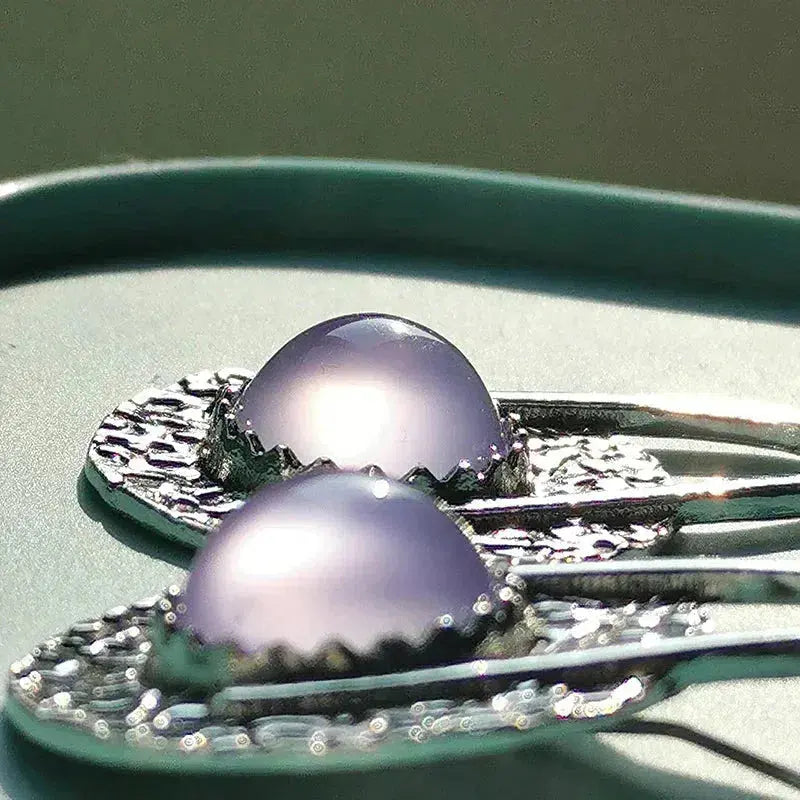 Boho earrings with purple stones in silver setting