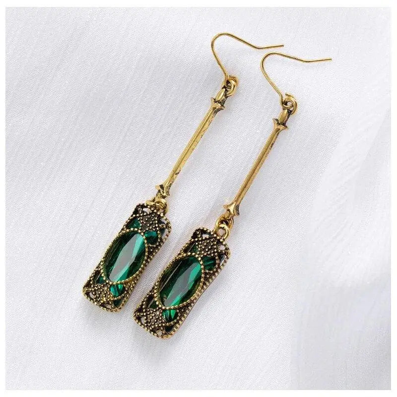 Gold pendant earrings with green lantern