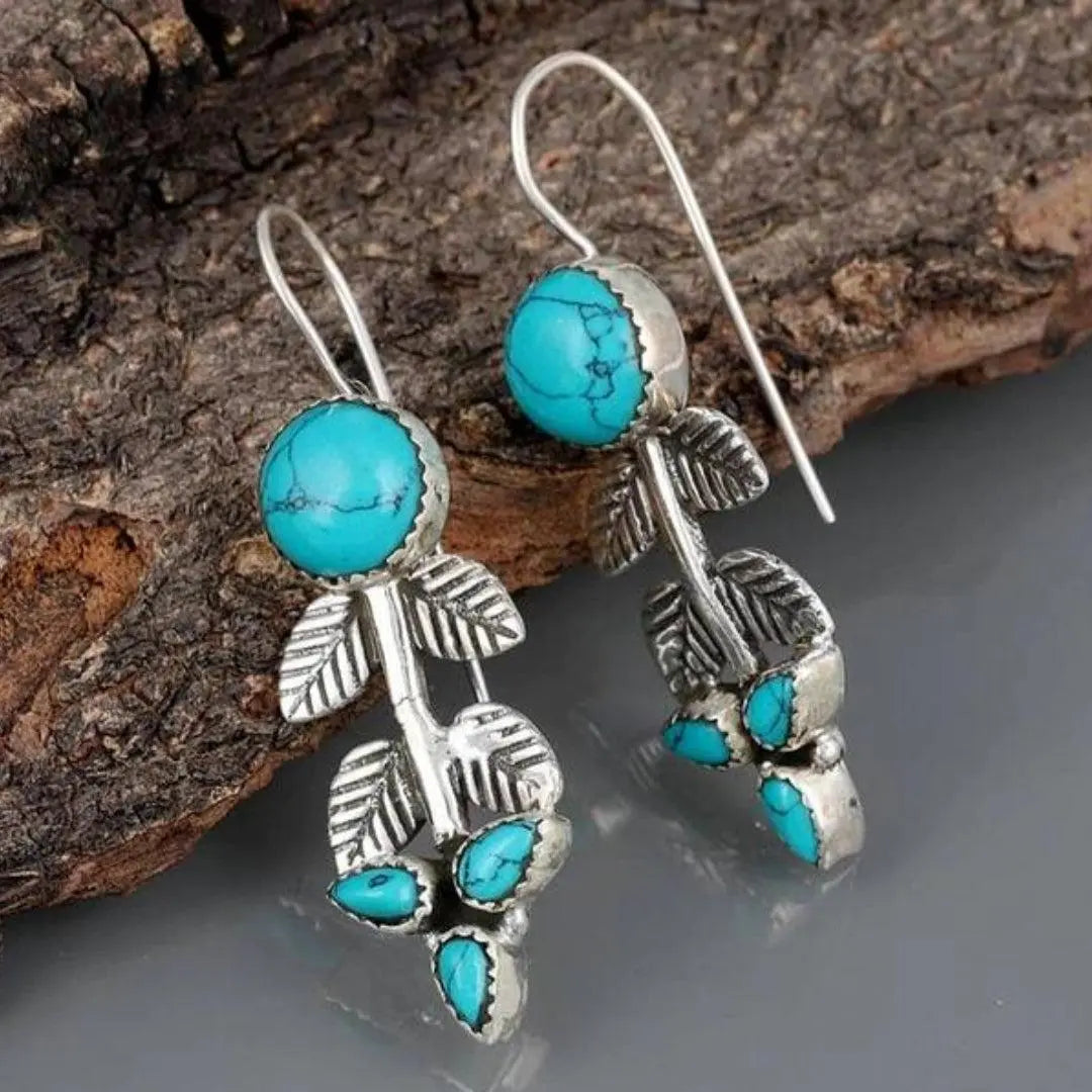 Silver earrings with opal in the shape of a leaf