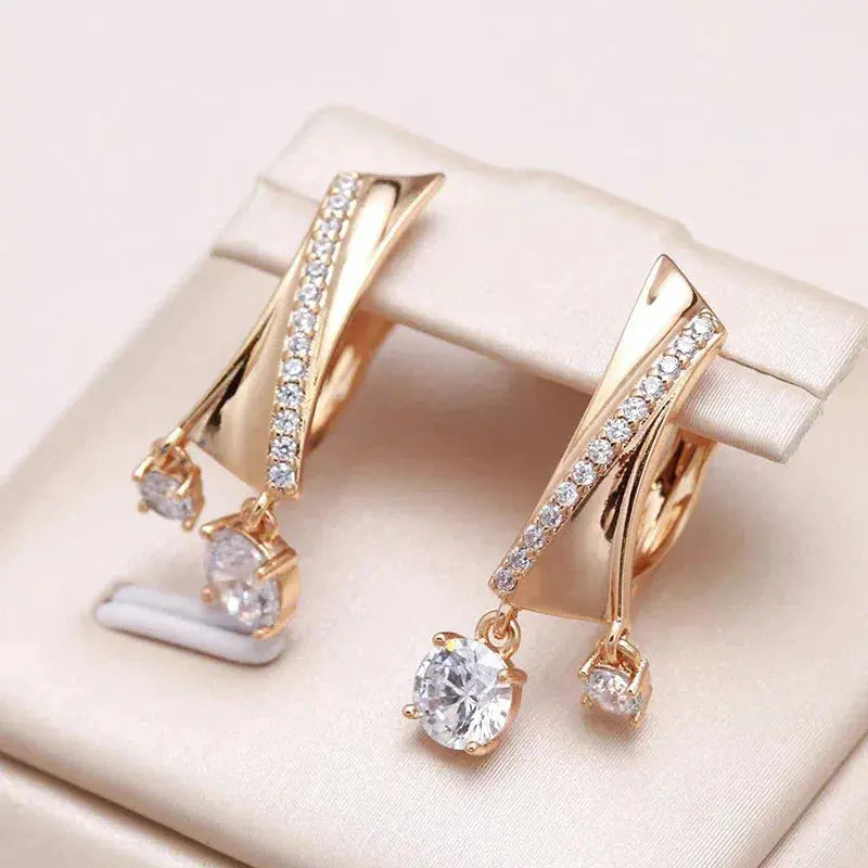 Elegant gold earrings with zircons and drops