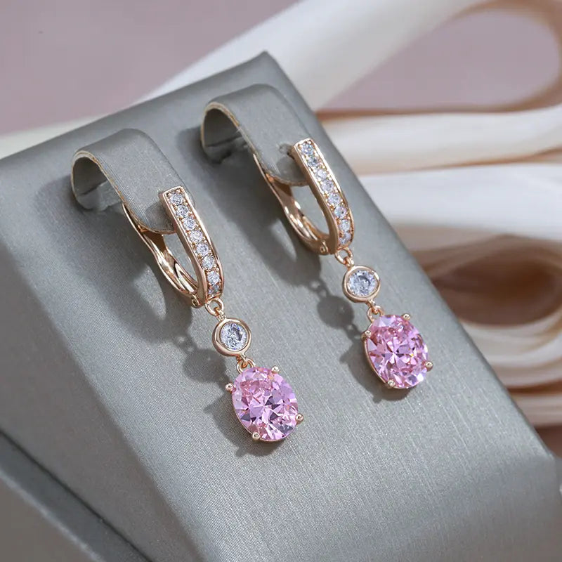 Gold pendant earrings with rose-colored crystals