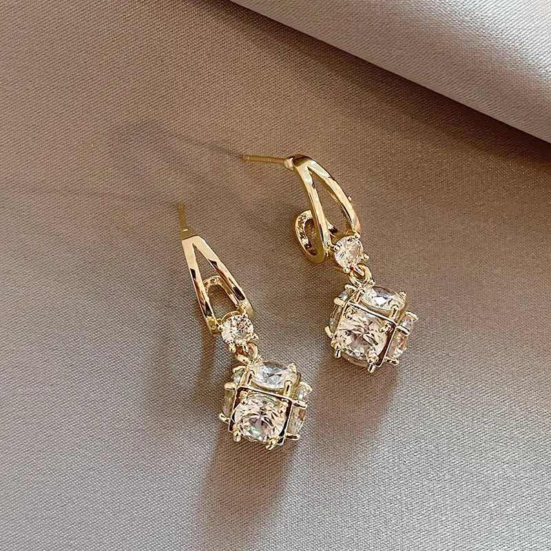 Elegant gold earrings with zircons
