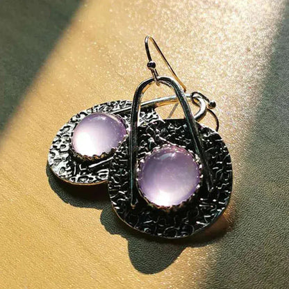 Boho earrings with purple stones in silver setting