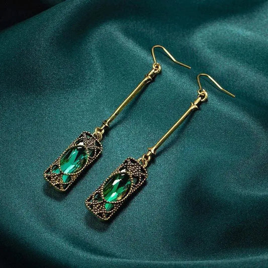 Gold pendant earrings with green lantern