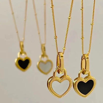 Black and white necklace with gold heart