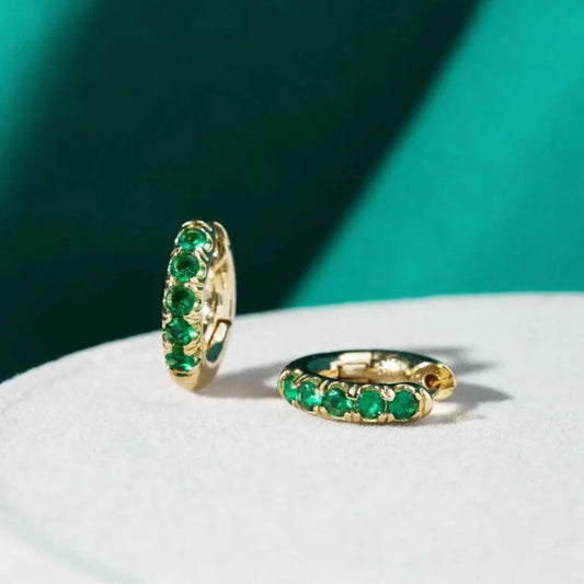 Gold earrings nuts with green zircons