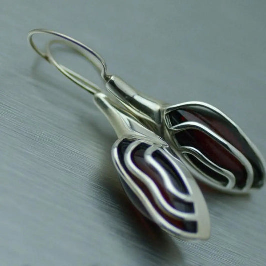 Silver earrings with dark red stone