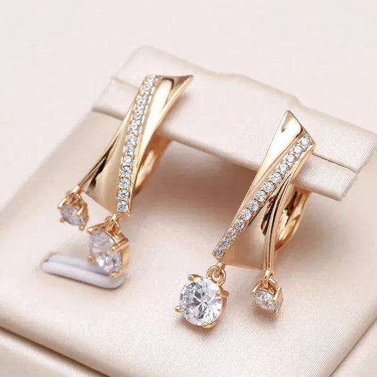 Elegant gold earrings with zircons and drops