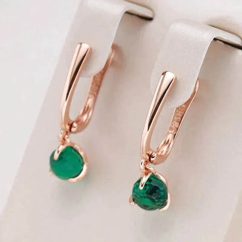 Elegant gold earrings with green crystals