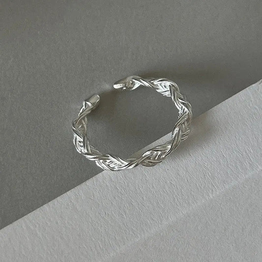 Braided silver ring with artistic design