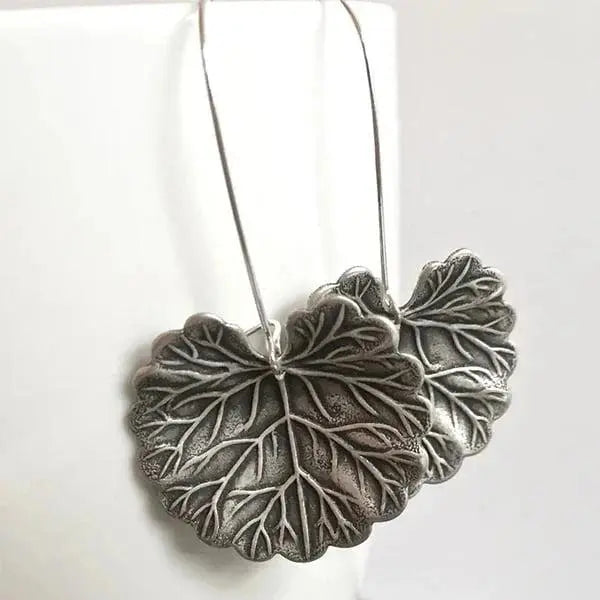Silver earrings in the shape of leaves