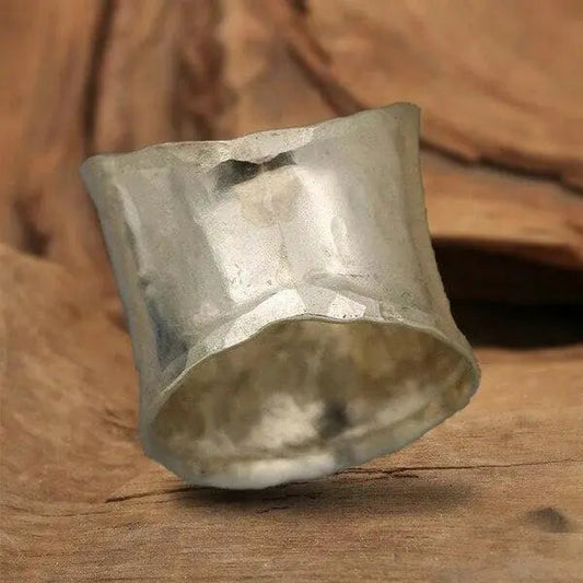 A ring in the shape of a blooming daisy with a wide band