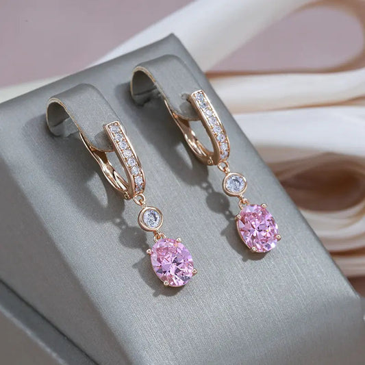 Gold pendant earrings with rose-colored crystals