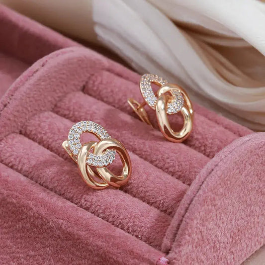 Elegant earrings with zircons in gold color