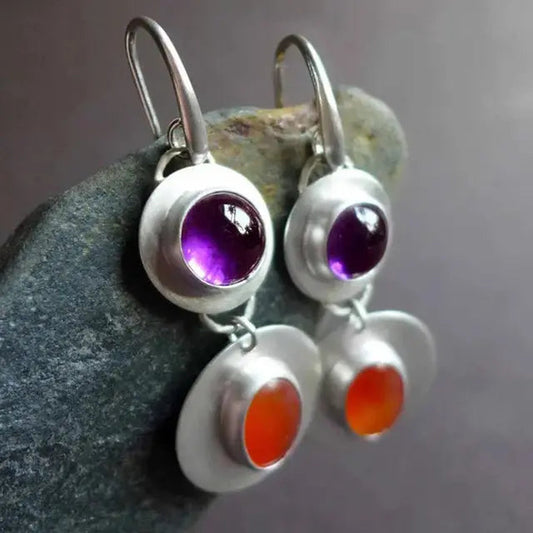 Earrings with red and purple crystals in a silver setting