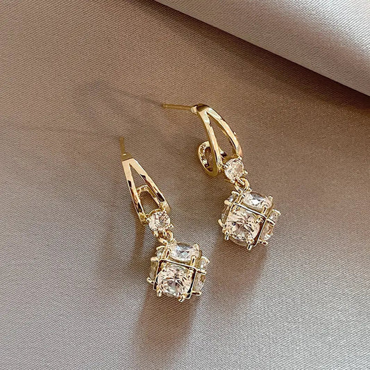 Elegant gold earrings with zircons