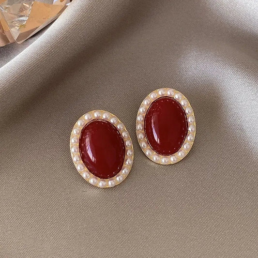Elegant oval earrings in gold and red color